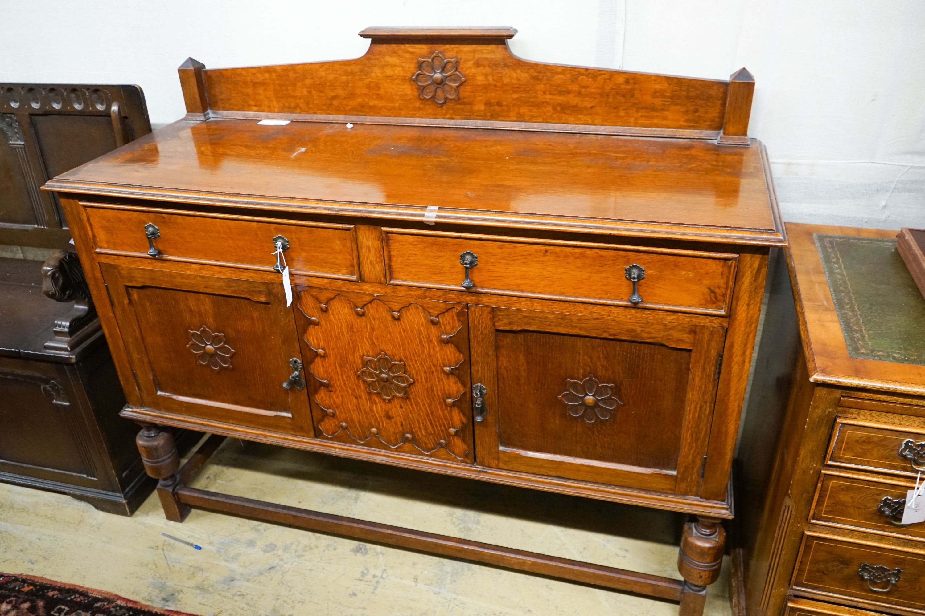 An 18th century style oak monks bench together with a 1920's oak sideboard